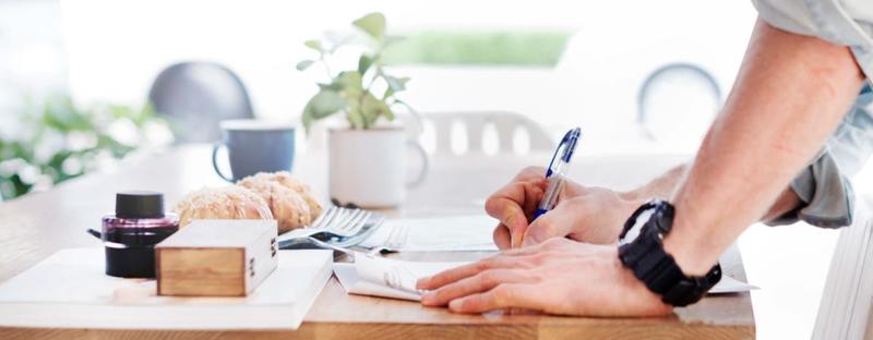 person writing on paper