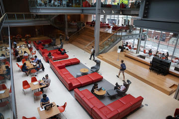 Aerial view of students at tables, chairs and couches in the Smith Campus Center.