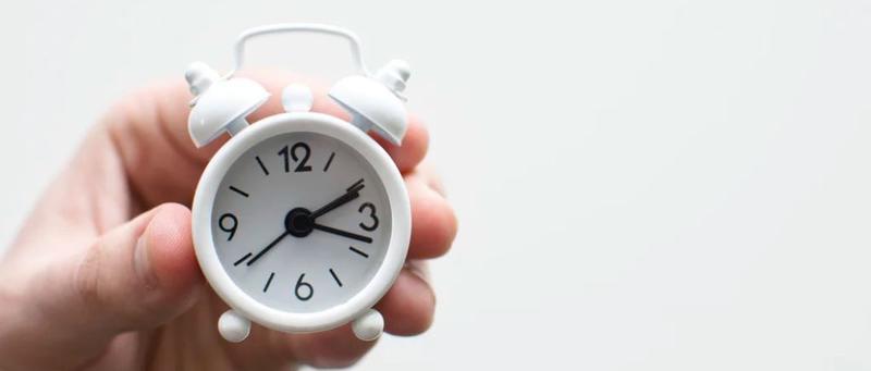 person holding clock